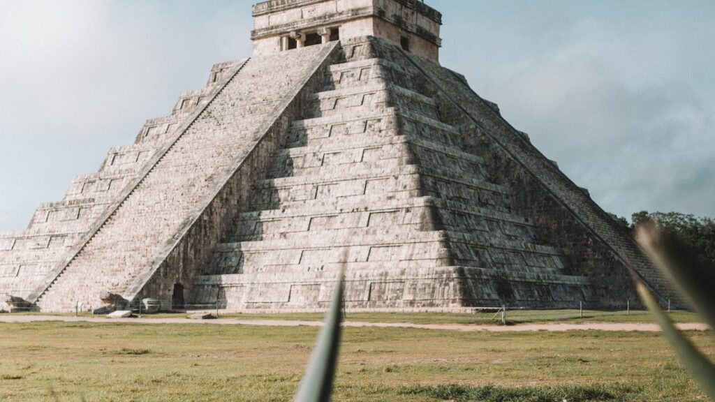 Gray pyramid on grass field during day