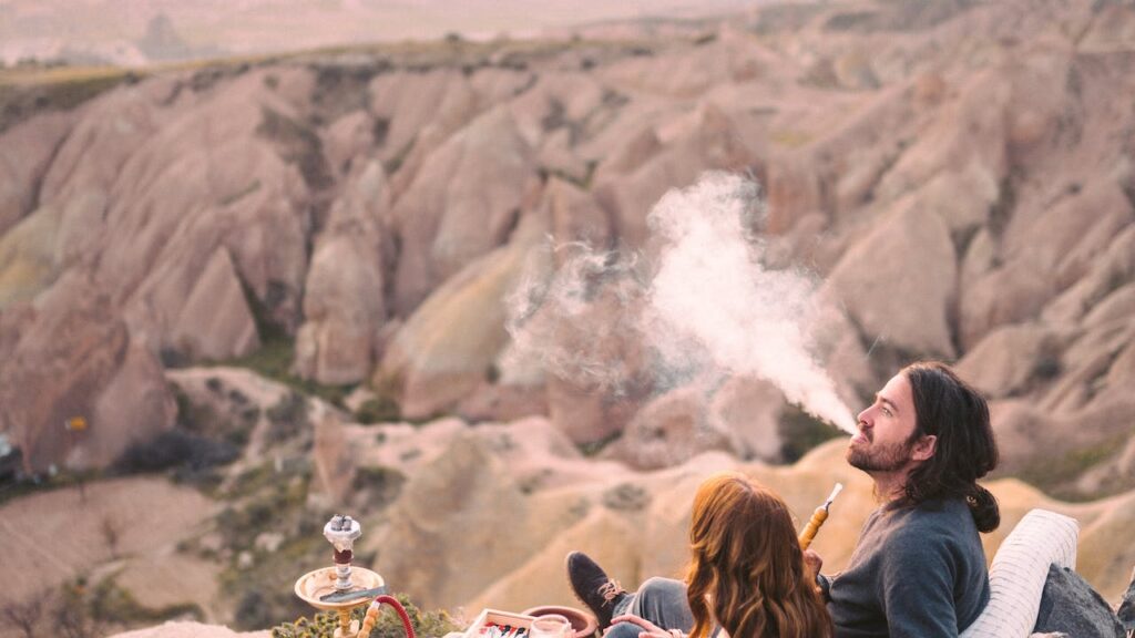 People sitting on pillows using shisha