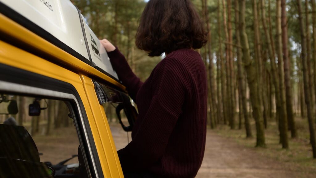 Woman sitting on the car s window